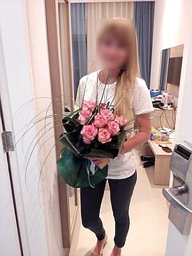 Pretty woman with a bouquet of 9 pink roses