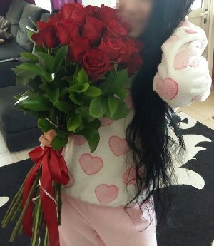 Girl with a bouquet of red roses